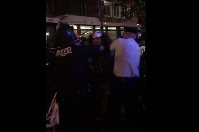 Four NYPD officers surround one protester as he is arrested in the West Village on Saturday, September 26.